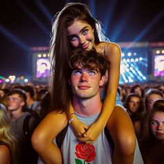 a man holding a woman in his arms at a concert