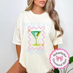 Get ready to celebrate your last fling before the ring in style with our Miami Bachelorette Party Shirt! This trendy and fashionable shirt is perfect for you and your bride squad to make a statement on your unforgettable weekend getaway. Made with love and care, our handcrafted shirts are not only stylish but also incredibly comfortable, ensuring you and your gal pals can have the best time together in the sunny Miami paradise. If you're looking for a thick, structured tee that's also super soft White Party Top For Beach Season, White T-shirt For Spring Holiday, Graphic Print Shirt For Summer Bachelorette Party, Summer Graphic Print Shirt For Bachelorette Party, White Spring Holiday T-shirt, Short Sleeve Summer Wedding Tops, Graphic Print Shirt For Bachelorette Party In Summer, Summer Crew Neck Shirt For Bachelorette Party, Crew Neck Shirt For Bachelorette Party In Summer