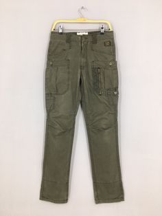 "Size 30x32 Japanese Back Number Slim Fit Cargo Pants Olive Slim Skinny Fit Pants Casual Multi Pocket Utility Streetwear Tactical Pant W30 Please contact me for any questions about this clothing before buying. SIZE MEASUREMENTS :- WAIST : 30\" inches HIPS : 36\" inches THIGH: 20\" inches LEG OPENING : 14\" inches RISE : 11\" inches INSEAM : 32\" inches OUTSEAM (TOTAL LENGTH) : 42\" inches WEIGHT : 0.60 kg Condition : Good Condition. No holes and no stains. Please pay close attention to measureme Combat Style Khaki Work Pants With Pockets, Military Style Khaki Cargo Jeans With Straight Leg, Military Style Work Pants With Cargo Pockets, Combat Style Straight Leg Cargo Jeans For Outdoor, Khaki Military Cargo Work Pants, Utility Cargo Pants With Belt Loops For Hiking, Combat Straight Leg Cargo Pants With Hip Pockets, Combat Cargo Pants With Straight Leg And Hip Pockets, Combat Style Straight Leg Cargo Pants