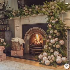 a fireplace decorated for christmas with ornaments around it