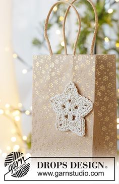 a brown paper bag with a crocheted star on it