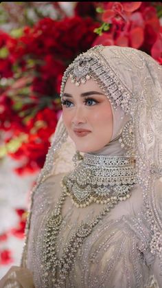 a woman wearing a white veil and headpiece