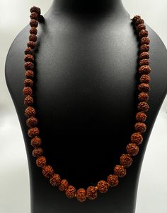 Immerse yourself in the sacred energy of our meticulously crafted Rudraksha Mala featuring 7mm beads. Handcrafted from authentic Rudraksha seeds, each bead carries a rich history of spiritual significance. Rudraksha beads are revered for their ability to enhance meditation, promote mindfulness, and attract positive energies. Key Features: Authentic Rudraksha Seeds: Sourced with care, each 7mm bead is a genuine Rudraksha seed, known for its powerful spiritual vibrations. Meticulous Craftsmanship: Our Rudraksha Mala is handcrafted with precision, ensuring the integrity of each bead and the overall aesthetic appeal of the necklace. Versatile Meditation Aid: The 7mm bead size strikes a perfect balance, making this mala ideal for both beginners and experienced practitioners. Use it for meditati Holistic Necklaces With 8mm Beads For Rituals, Spiritual Hand-strung Beaded Necklaces For Rituals, Holistic Necklaces With 8mm Beads For Festivals, Spiritual Round Beads Jewelry For Puja, Spiritual Mala With 8mm Beads For Rituals, Spiritual Gemstone Beads For Rituals, Spiritual Beaded Necklaces For Meditation And Festivals, Traditional Jewelry For Meditation With 8mm Beads, Spiritual Necklaces With 8mm Beads For Rituals