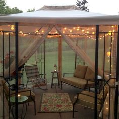 a gazebo with chairs and lights on it