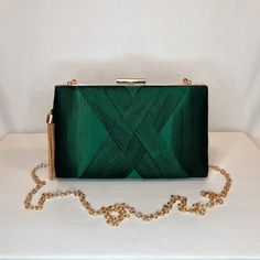 Womens dark green satin evening clutch bag with ruched detailing, gold tassel embellishment and top closing clasp Can be used with or without long shoulder chain (included) size approx- H 12cm x W 20cm Optional Dust Bag: White lightweight soft polyester portable travel dust bag pouch, suitable for protecting items from dust, dirt, hairs and scratches when not in use size approx- L 47cm x W 31.5cm Material: 100% polyester Please note, there is a cut in the top corner of the bag. In order to revea Elegant Green Bag For Night Out, Green Elegant Evening Bag, Chic Green Evening Bag, Forest Dark Green, Forest Dark, Shoulder Chain, Evening Clutch Bag, Green Satin, Evening Clutch