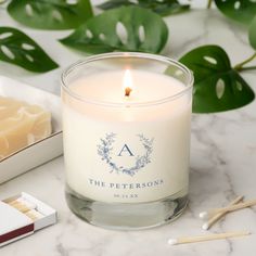 the personalized candle is next to matches and a box of matches on a marble table