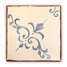 a blue and white tile with swirls on it