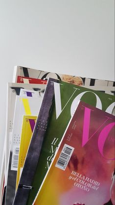 several magazines stacked on top of each other