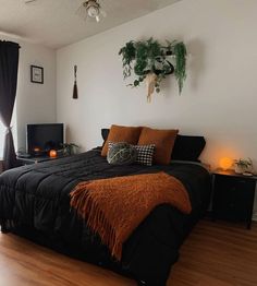 a bed room with a neatly made bed and wooden floors