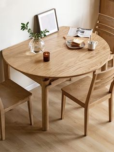 a wooden table with two chairs around it