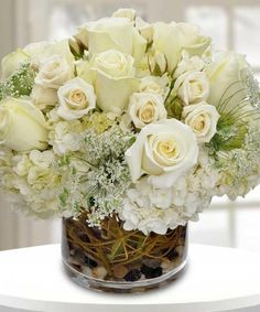 a vase filled with white flowers on top of a table