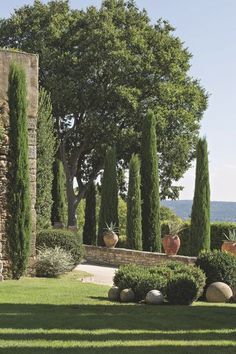 an outdoor garden with stone walls and trees