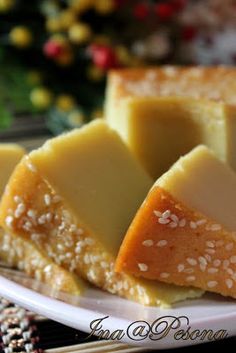 pieces of cheesecake on a white plate with sesame seeds and sprinkles