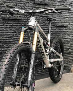 a bike parked in front of a brick wall