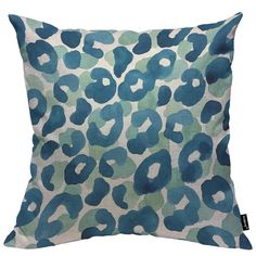 a blue and green leopard print pillow on a white background