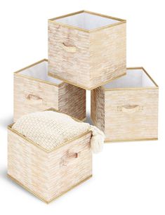 four wooden storage boxes with lids and handles on each side, all stacked up against one another