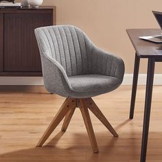 a grey chair sitting on top of a wooden table