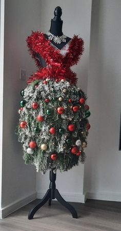 a mannequin is decorated with christmas ornaments and red, white and green decorations