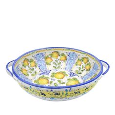 a blue and white bowl with lemons on it