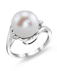 This beautiful pearl ring features a lustrous AAAA quality 10-11mm Freshwater pearl. The pearl is mounted with dazzling SI clarity diamonds on a 14K gold band. This ring is available in a number of sizes for the perfect fit. Luxury Stackable Pearl Ring For Wedding, Luxury Stackable Pearl Ring For Formal Occasions, Luxury Oval Pearl Ring For Wedding, Luxury White Pearl Gemstone Ring, Luxury Delicate Pearl Engagement Ring, Luxury Timeless Diamond White Pearl Ring, Luxury Pearl Promise Ring For Women, Luxury Pearl Ring In Diamond White, Pearl Rings