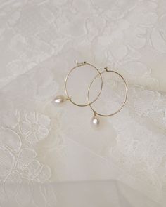 Freshwater Pearl Hoop Earrings in Gold filled or Stelring Silver -1 Pair -Lightweight wire -Hoop measures about 25mm in diameter --------------------------------------- ■ SHIPPING UPGRADES You can find shipping upgrades options in the drop bar menu when you check out. * Within the U.S Regular First-class : 2-6 business days Priority : 2-3days Express : 1-2 days * International International Priority : 6-10 Business days Rush International Express : 3-6 business days * Our current processing time Small Hoop 14k Gold Filled Pearl Earrings, Minimalist Hoop Pearl Earrings With Ear Wire, Delicate Dangle Hoop Earrings With Pearl Drop, Delicate Small Hoop Earrings With Ear Wire, Delicate Hypoallergenic Hoop Jewelry, Delicate Wire Wrapped Round Earrings, Delicate Small Hoop Pearl Drop Jewelry, Small Hoop Single Earring For Wedding, Delicate Hypoallergenic Hoop Earrings For Weddings