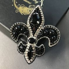 a black and white brooch sitting on top of a book