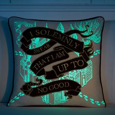 a pillow that is lit up with green light on the side and black lettering reading, i solemnly sure that i am up to no good