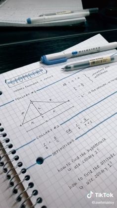 notebooks and pens sitting on top of a table