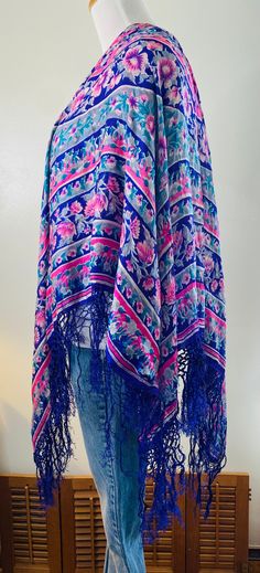 "Very Daisy Jones, here is a vintage shawl/scarf, purple with pink flowers and gray accents. Very delicate 100% pure silk with hand knotted purple fringe all around. Measures 36\" in diameter. PLEASE NOTE: This pretty vintage scarf does have some minor pinholes and one area where it has been mended, see photos. Still too beautiful to discard. Wear it as a wrap, drape it over a chair or table, many uses. Very cool." Floral Print Shawl Scarf One Size, One Size Floral Print Shawl Scarf, Spring Shawl With Tassels, One Size Bohemian Scarf With Floral Print, Floral Print Shawl Scarf, Bohemian Scarves With Floral Print, One Size, Pink Shawl Scarf For Festivals, One Size Bohemian Scarves With Floral Print, One Size Silk Shawl Scarf For Spring