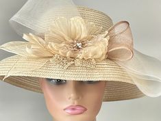 "The featured listing is a dressy wide brimmed pale gold straw hat. A  crinkle organza pale gold flower sits in the center of the hat. Sinamay loops in ivory and tan are set around the center flower. A very large multi layered ivory crinoline bow extends out and over the brim of the hat.  All the elements combining  making the hat so interesting and softly dramatic. This  hat is  beautiful for the Kentucky Derby or  for  Sunday  Church.  It is also perfect for an Easter Hat, Tea Party hat,Weddin Beige Sun Hat With Upf 50+ For Kentucky Derby, Adjustable Country-style Hats For Kentucky Derby, Beige Straw Hat For Kentucky Derby, One Size, Pink Sun Hat For Wedding, Kentucky Derby, Luxury Six-panel Hat For Kentucky Derby, Gold Straws, Sunday Church, Easter Hats, Tea Party Hats