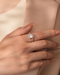 a woman's hand with a diamond ring on her finger