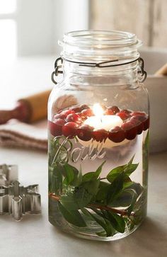 a glass jar filled with water and candles