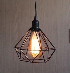 a light that is hanging from a wire with a bulb on it's side