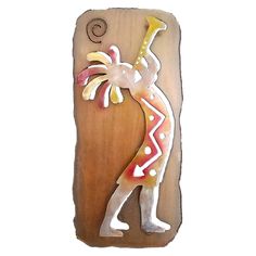 a wooden plaque with an image of a woman dancing