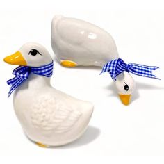 two ceramic ducks with blue and white bows