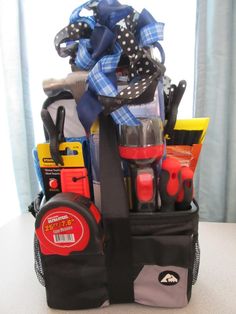 a black bag filled with tools on top of a white table next to a window