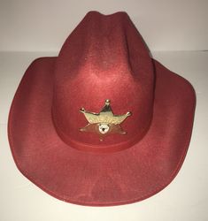 This is an authentic vintage children's red felt cowboy hat from 1992 in excellent condition. I am the original owner of this item and there are no rips, cuts or imperfections. It is from a smoke free home. It comes with an original brass and enamel sheriff star which came with the hat. The hat itself is pretty roomy for a child and is about an adult size 6 7/8 and includes a leatherette band around the crown. Great for your collection, parties, Halloween costumes or fun! Shipping is by USPS to the continental US only. Thanks very much for looking. Red Western Hat For Western-themed Events, Adjustable Red Felt Hat For Western-themed Events, Red Fedora For Western-themed Events, Sheriff Star, Felt Cowboy Hat, Felt Cowboy Hats, Red Felt, The Continental, Cowboy Hat