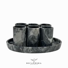 marbled tray with six cups on it and the words boocanebra written in white