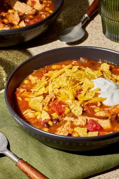 a bowl of chicken tortilla soup with sour cream