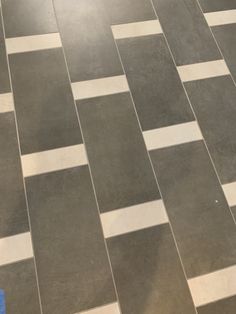 a black and white checkered tile floor with a blue towel on the ground next to it