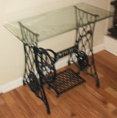 a glass table sitting on top of a hard wood floor