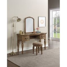 a wooden vanity with mirror and stool in a room