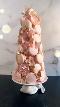 a pink and gold christmas tree made out of macaroni shells