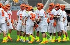 a group of lacrosse players standing on top of a field