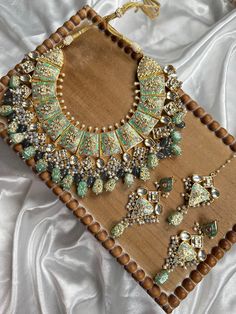 This Beautiful Rajasthani set comes with matching earrings and it made of high quality handwork and kundan work. The handpainted colors are beautiful and can go with many outfits as a statement piece. It is made from high quality stones and is a full choker that covers the neckline. The work is intricate and very beautiful in person. Pista Green Kundan Anarkali Set For Navratri, Pista Green Kundan Anarkali Set With Pallu, Pista Green Anarkali Set With Kundan And Pallu, Festive Pista Green Set With Meenakari Details, Festive Pista Green Sets With Meenakari, Pista Green Anarkali Set With Pallu And Kundan, Festive Pista Green Meenakari Anarkali Set, Festive Pista Green Anarkali Set With Meenakari, Meenakari Chandbali Sets For Festive Occasions