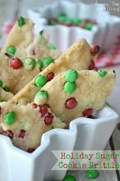 some food is in a white bowl on a table with green and red sprinkles