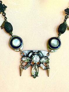 I made this eclectic art deco, goth, rock and roll vintage cool mother of pearl necklace. It measures 20", but also has a generous extender.. Includes vintage cuff links and vintage crystal. Vintage Jeweled Choker Necklace, Retro Metal Jewelry, Vintage Bronze Necklace For Party, Vintage Jewelry Choker With Unique Variations, Vintage Jewelry With Unique Design For Formal Occasions, Vintage Formal Jewelry With Unique Design, Antique Metal Necklace For Parties, Antique Metal Necklace For Party, Unique Vintage Charm Necklace For Formal Occasions