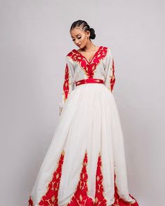 This Habesha dress is a true work of art, made of soft and luxurious Menen fabric in a regal red color. The dress features a stunning Tilf embroidery design, covering the entire dress with intricate patterns and designs that are unique to Ethiopian traditional clothing. The Tilf embroidery adds a touch of elegance and sophistication to the dress, featuring delicate patterns and designs that are sure to turn heads. The dress is designed with a fitted bodice that accentuates the waistline and flar Traditional Formal Dresses For Festivals, White Ceremonial Dress For Festivals, Ceremonial White Dresses For Festivals, Ceremonial Long Sleeve Maxi Dress, White Ceremonial Dress For Eid, Traditional White Formal Dress, Red Long Sleeve Dresses With Traditional Patterns, Red Long Sleeve Dress With Traditional Patterns, Elegant Long Sleeve Dresses For Festivals