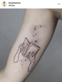 a person with a book tattoo on their arm