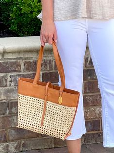 Made from harvested rattan and tan grain leather, this trendy boho cane weave tote bag features a convenient snap closure with a stylish strap. The cognac color and trim with a zipper pocket makes this purse fashionable, multi-purpose and easy to use.